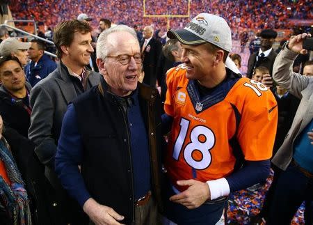 Jan 24, 2016; Denver, CO, USA; Denver Broncos quarterback Peyton Manning (18) greets father Archie Manning and brother Eli Manning after defeating the New England Patriots in the AFC Championship football game at Sports Authority Field at Mile High. Mandatory Credit: Mark J. Rebilas-USA TODAY Sports