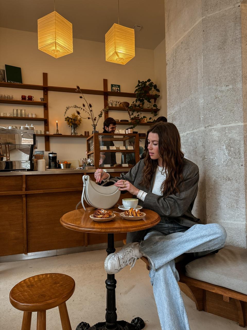 A woman going through her purse at a restaurant.