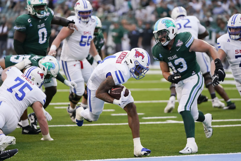 SMU running back Jaylan Knighton (4) carries against Tulane linebacker Tyler Grubbs (13) for a touchdown during the first half of the American Athletic Conference Championship NCAA college football game , Saturday, Dec. 2, 2023 in New Orleans. (AP Photo/Gerald Herbert)