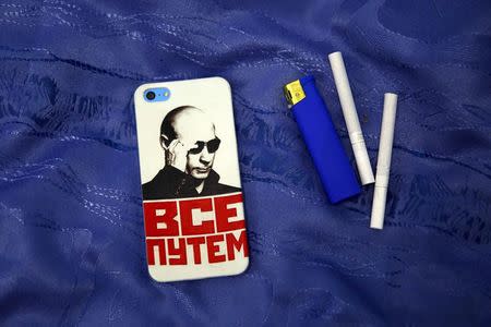 A mobile phone cover with a picture of Russian President Vladimir Putin and which reads "Everything is fine" is seen in this photo illustration taken in a hotel room in Kazan, Russia, August 5, 2015. REUTERS/Stefan Wermuth