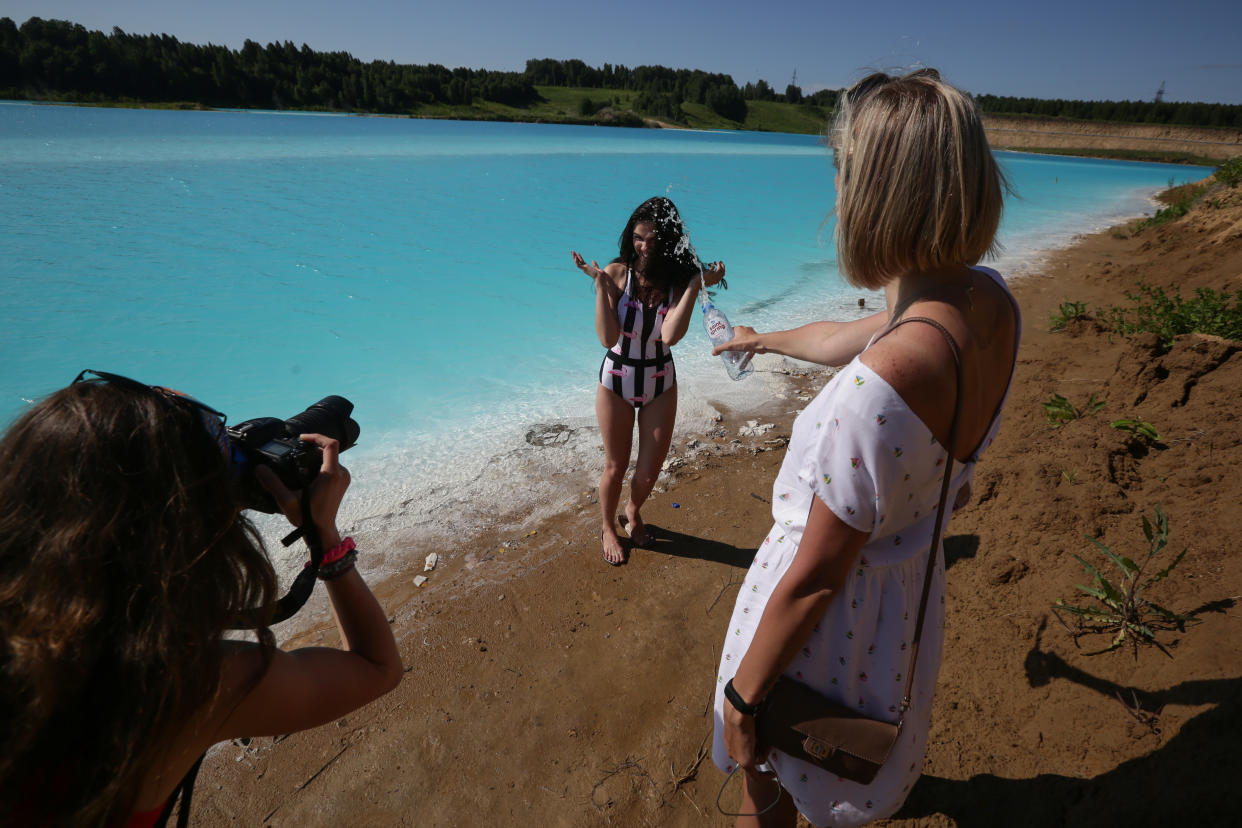 A young woman poses for pictures by a Novosibirsk energy plant's ash dump site - nicknamed the local "Maldives" - on July 11, 2019. (Photo: Rostislav Netisov/AFP/Getty Images)