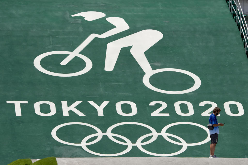 A worker looks at the start ramp at the BMX racing track as preparations continue for the 2020 Summer Olympics, Tuesday, July 20, 2021, at the Ariake Urban Sports Park in Tokyo. (AP Photo/Charlie Riedel)