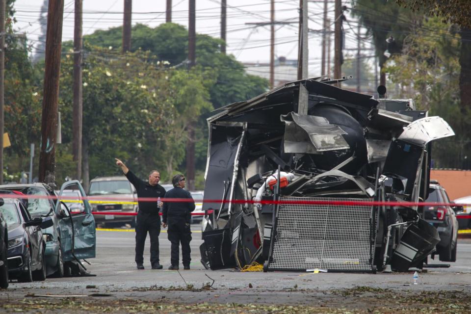 A destroyed bomb squad vehicle on a street