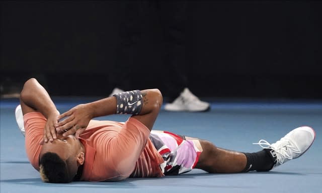 Nick Kyrgios lies on the court after his dramatic victory