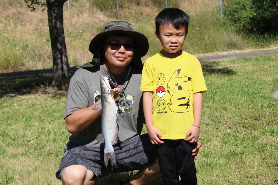 Chao and Bradley Vang display the channel catfish that Bradley caught during the CDFW Fishing in the City event at Granite Regional Park on May 15, 2024.