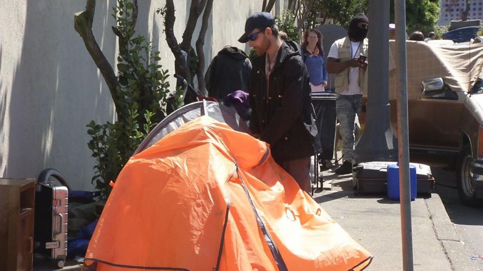 PHOTO: An unhoused former restaurant worker packs up his tent on the streets of San Francisco. (ABC News)