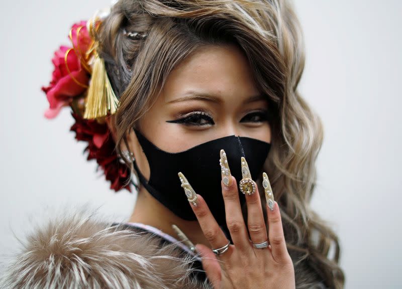 Kimono-clad woman wearing a face mask poses for a photograph at Coming of Age Day celebration ceremony amid the coronavirus disease (COVID-19) outbreak, in Yokohama, Japan