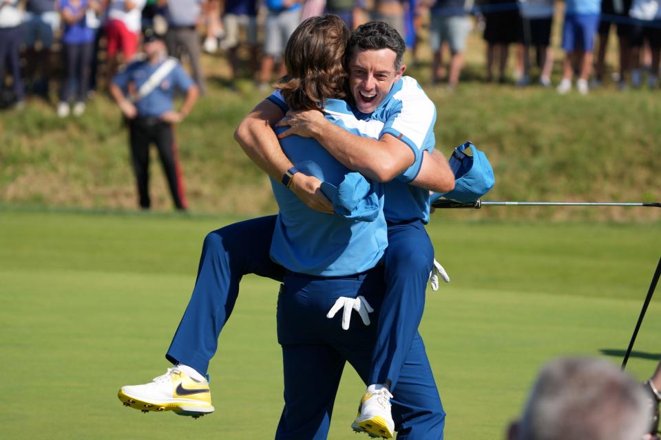 Team Europe golfer Tommy Fleetwood and golfer Rory McIlroy celebrate on the seventeenth green during day one foursomes round for the 44th Ryder Cup golf competition at Marco Simone Golf and Country Club.