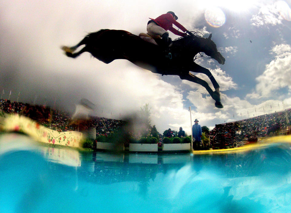 <p>In this photo made using a fisheye lens, Jaime Azcarraga, of Mexico, rides his horse Gangster, in the equestrian show jumping team competition at the 2012 Summer Olympics, Aug. 5, 2012, in London. (AP Photo/David Goldman) </p>