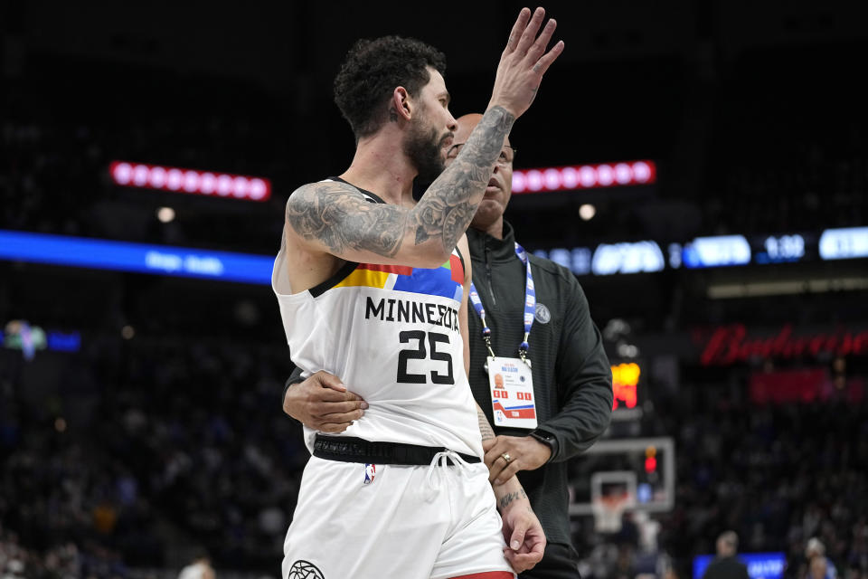 Minnesota Timberwolves guard Austin Rivers (25) exits the game after being ejected for participating in a scrum against the Orlando Magic during the second half of an NBA basketball game, Friday, Feb. 3, 2023, in Minneapolis. (AP Photo/Abbie Parr)