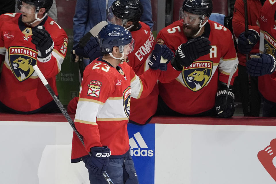 Florida Panthers center Carter Verhaeghe (23) is congratulated by his teammates after scoring a goal during the first period of an NHL hockey game against the Philadelphia Flyers, Tuesday, Feb. 6, 2024, in Sunrise, Fla. (AP Photo/Marta Lavandier)