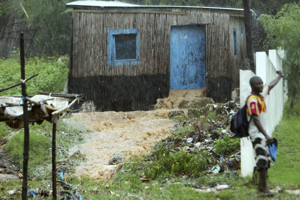 Water gushes out from a house, in Pemba, on the northeastern coast of Mozambique, Sunday, April, 28, 2019. Serious flooding began on Sunday in parts of northern Mozambique that were hit by Cyclone Kenneth three days ago, with waters waist-high in areas, after the government urged many people to immediately seek higher ground. Hundreds of thousands of people were at risk. (AP Photo/Tsvangirayi Mukwazhi)