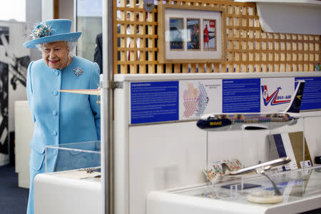 Britain's Queen Elizabeth looks exhibits in the Heritage Centre during her visit to the headquarters of British Airways, as British Airways mark their centenary year, in Heathrow, west London, Britain May 23, 2019. Tolga Akmen/Pool via REUTERS