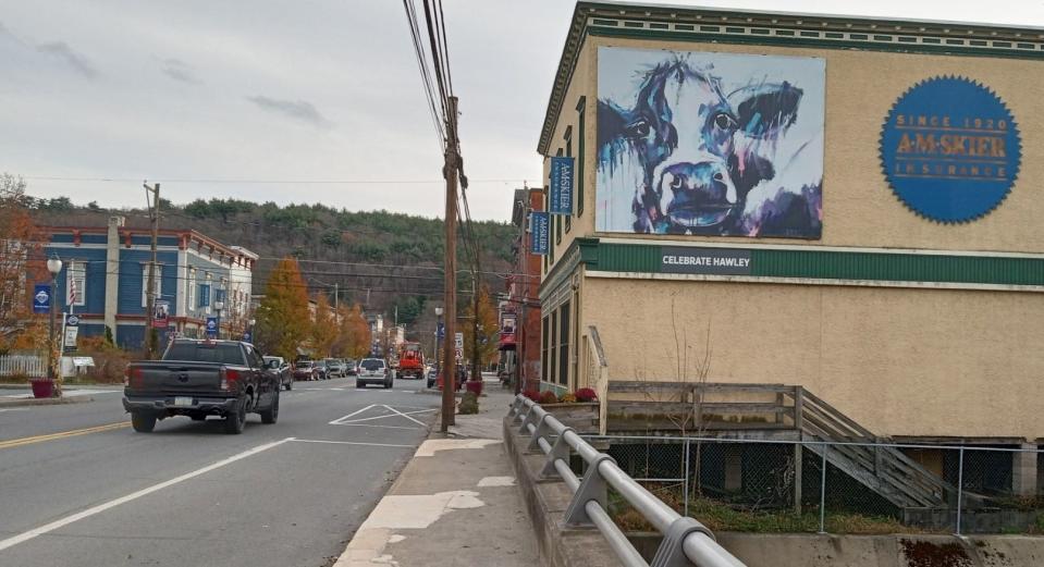 Wayne County Arts Alliance, working with Downtown Hawley Partnership and the Foundation for Harmony Presents, is proceeding again to make Hawley an art destination with street banners featuring art by regional artists. A second phase of "Paint the Town" will be to add more art murals to downtown building exteriors, which started in 2019 with "Moo," a painting by Ula Nero of Damascus. Moo continues to greet visitors to downtown Hawley from the side of the 126 Main Ave. building of AMSkier Insurance.