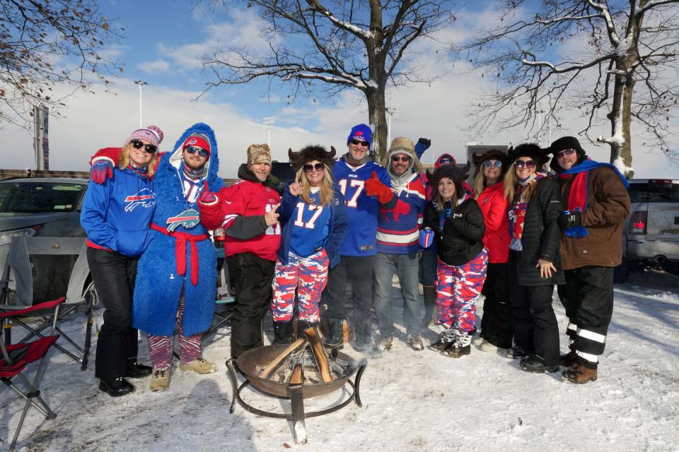 Fans tailgate in the snow before the AFC wild-card game between the Buffalo Bills and Pittsburgh Steelers at Highmark Stadium in Orchard Park, New York.