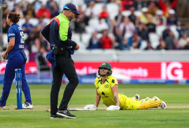 Australia’s Ashleigh Gardner, right, pushes herself up off the ground after being run out