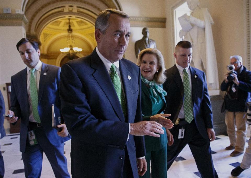 After being greeted by Rep. Carolyn Maloney, D-NY, center right, House Speaker John Boehner of Ohio leaves the House chamber on Capitol Hill in Washington, Friday, March 14, 2014, where the Republican-controlled House voted for the 51st time in 26 months to neuter the nation's health care law. With the vote 238-181 and nearly all Democrats opposed, the bill now goes to the Senate, where it's expected to die. The measure would overhaul the system for paying doctors and others who treat Medicare patients. At the same time, it delays the penalty for failing to purchase coverage under the law. (AP Photo/J. Scott Applewhite)