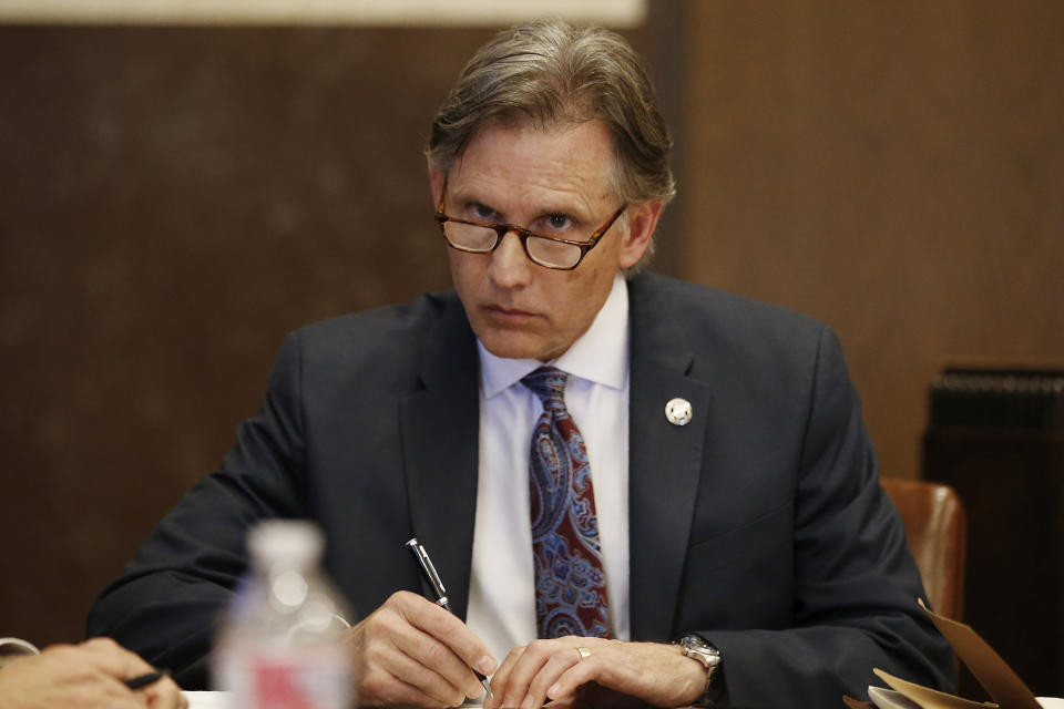 Oklahoma Attorney General Mike Hunter takes notes during a recess in a hearing to settle disagreements between Johnson & Johnson and the State over Judge Thad Balkman's final judgement in the opioid lawsuit, Tuesday, Oct. 15, 2019 in Norman, Okla. (AP Photo/Sue Ogrocki)