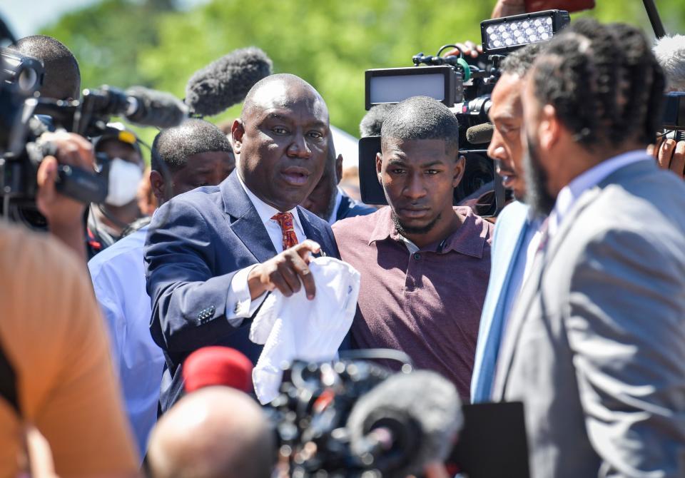 Civil rights attorney Benjamin Crump, left, puts his arm around George Floyd's son Quincy Mason at a memorial site for Floyd at 38th Street and Chicago Avenue in Minneapolis, June 3, 2020.