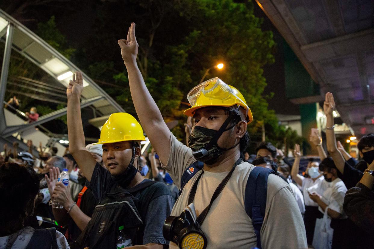 Thai pro-democracy protesters hold up a three finger salute at a rally in Bangkok on Monday (Getty Images)