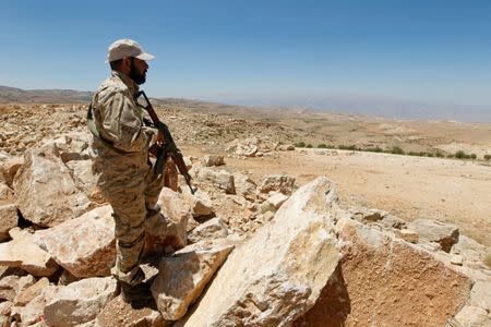 A Hezbollah fighter holds his weapon at Juroud Arsal, Syria-Lebanon border, July 25, 2017. REUTERS/Mohamed Azakir