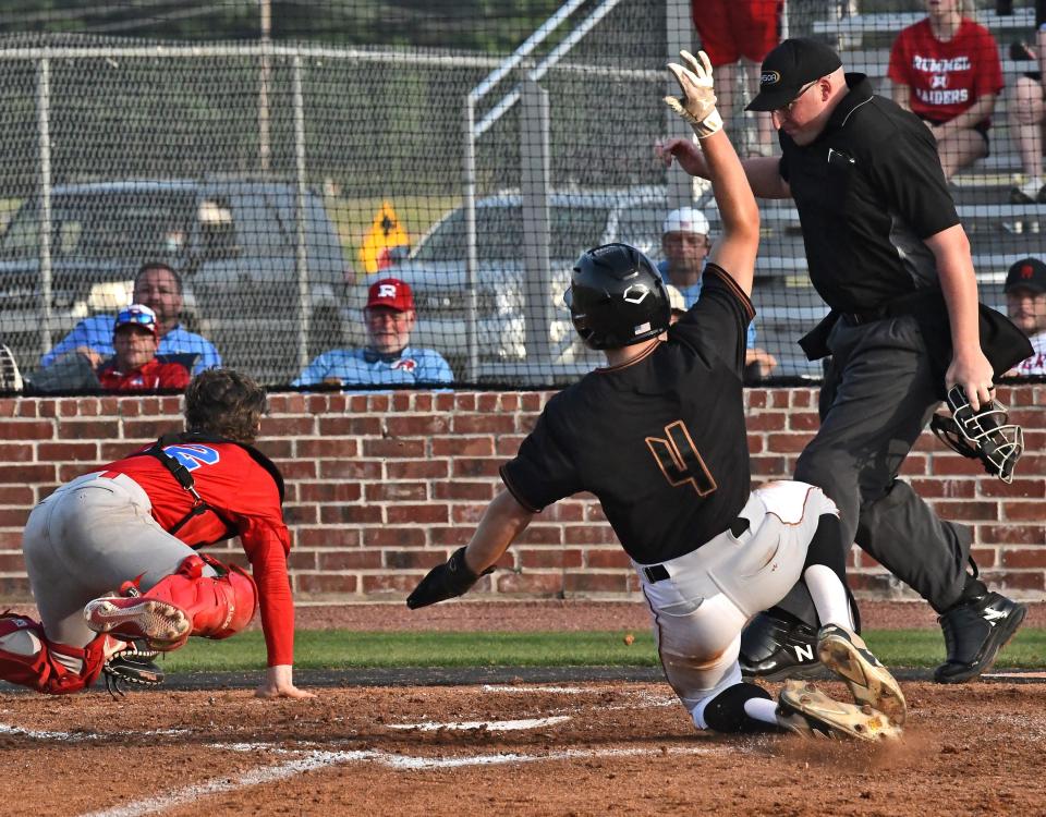 Northwood's Tucker McCabe slides into home with the second Falcons run against Rummel.