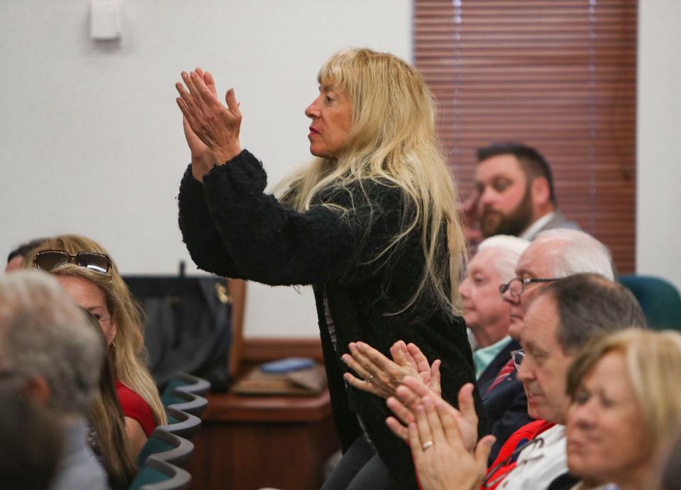 Opponents of the COVID-19 Extra Mile Migrant Farmworker Community Grant applaud the boards decision to return the money from the grant during a Collier County commission meeting at the Collier County administration building in Naples on Tuesday, Feb. 14, 2023. 