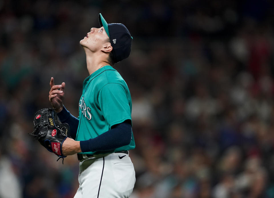 Seattle Mariners starting pitcher Bryan Woo walks off the field after pitching during the fifth inning of the team's baseball game against the Los Angeles Angels, Tuesday, Sept. 12, 2023, in Seattle. (AP Photo/Lindsey Wasson)