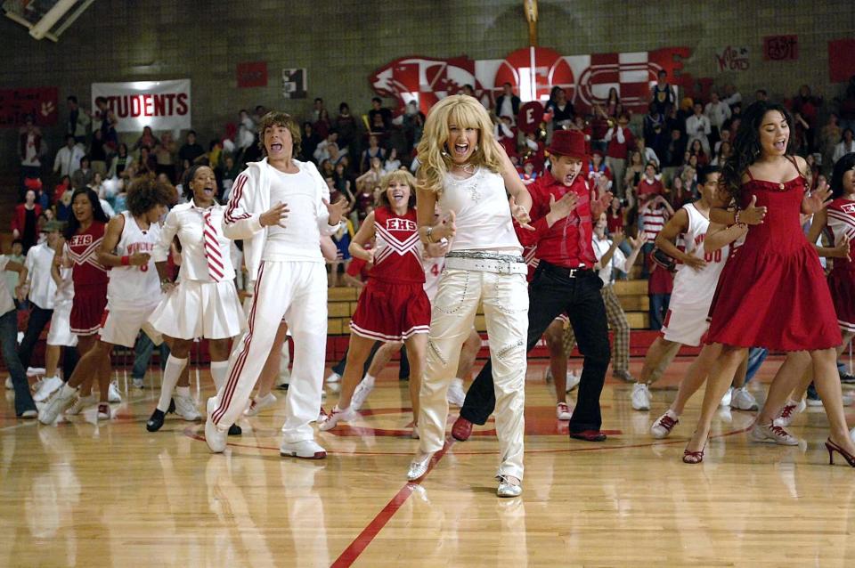 the cast of high school musical dancing in a school gym