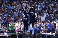 Chicago Cubs' Patrick Wisdom, right, celebrates with third base coach Willie Harris after hitting a two-run home run during the fifth inning of a baseball game against the Milwaukee Brewers in Chicago, Friday, Aug. 19, 2022. (AP Photo/Nam Y. Huh)