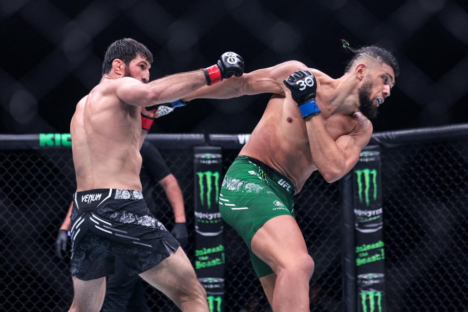 Russia’s Magomed Ankalaev (black) and Brazil’s Johnny Walker (green) compete in their Light Heavyweight bout during the Ultimate Fighting Championship 294 (UFC) event at the Etihad Arena in Abu Dhabi on October 21, 2023. (Photo by Giuseppe Cacace, Getty Images)