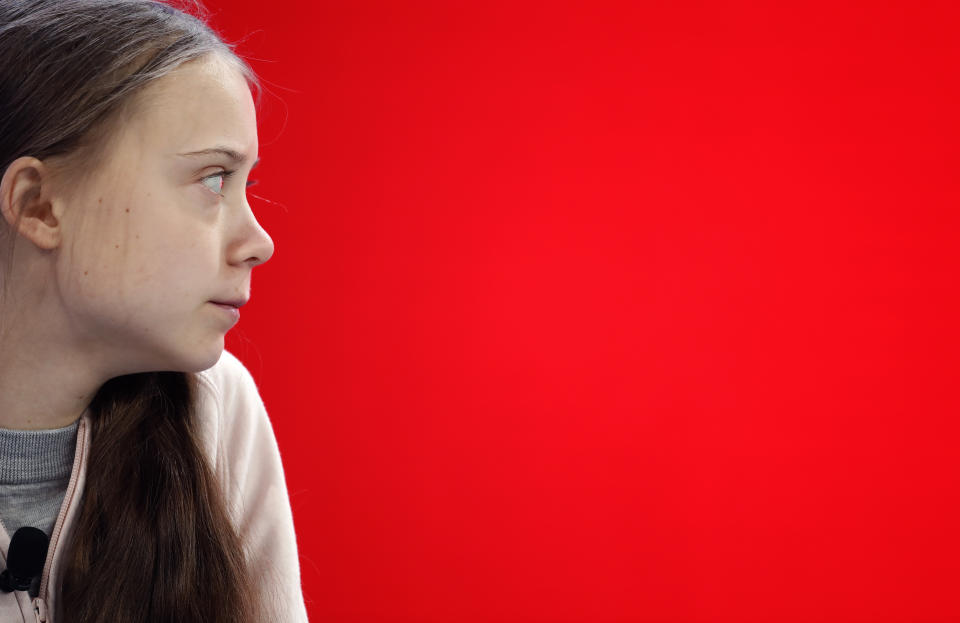 Swedish environmental activist Greta Thunberg takes her seat prior to the opening session of the World Economic Forum in Davos, Switzerland, Tuesday, Jan. 21, 2020. The 50th annual meeting of the forum will take place in Davos from Jan. 20 until Jan. 24, 2020. (AP Photo/Markus Schreiber)