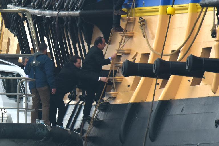 French President Francois Hollande climbs aboard a replica of the French navy frigate L'Hermione, before it sets sail on its maiden voyage to the United States from Fouras, southwestern France on April 18, 2015