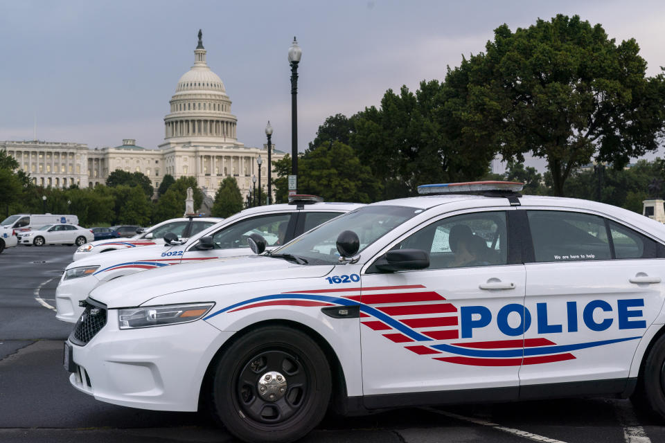FILE - Washington Metropolitan Police vehicles hold on the perimeter of the Capitol in Washington, Aug. 26, 2021. The head of the D.C. Council said Monday, March 6, 2023, that he is withdrawing the capital city’s new criminal code from consideration, just before a U.S. Senate vote that seemed likely to overturn the measure. But it's unclear if the action will prevent the vote or spare President Joe Biden a politically charged decision on whether to endorse the congressional action. (AP Photo/J. Scott Applewhite, File)