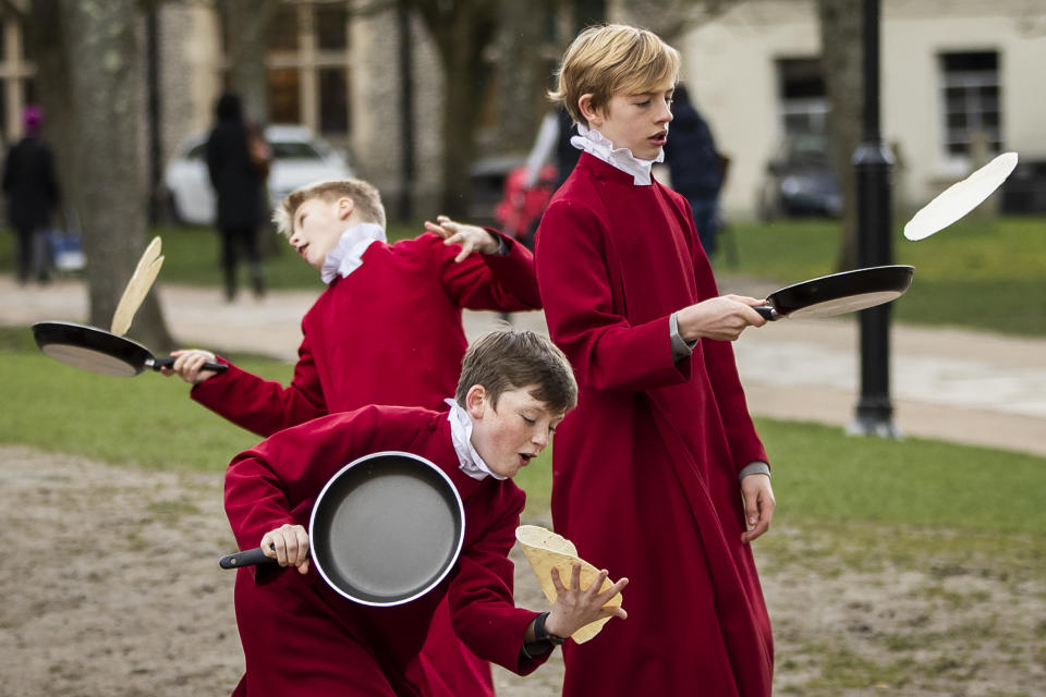 WINCHESTER, ENGLAND - MARCH 05: Choristers from Winchester Cathedral joke around in between being posed up for pictures by photographers on March 5, 2019 in Winchester, England. Winchester Cathedral held it's inaugural Shrove Tuesday Pancake day race in the Cathedral grounds today with money raised going to local charities. (Photo by Dan Kitwood/Getty Images)