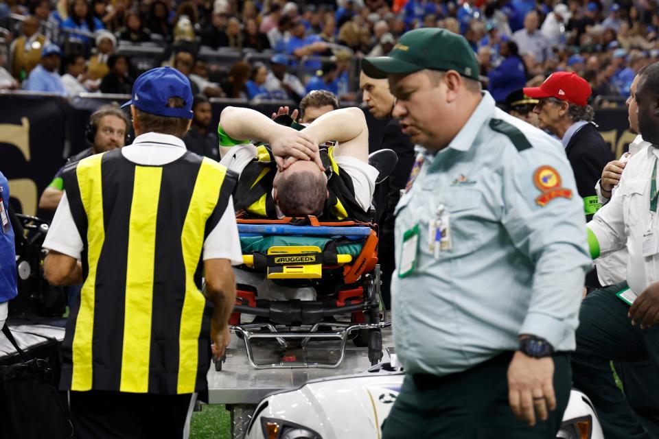 A member of the chain crew is wheeled off during the first half of an NFL football game between the New Orleans Saints and the Detroit Lions, Sunday, Dec. 3, 2023, in New Orleans.