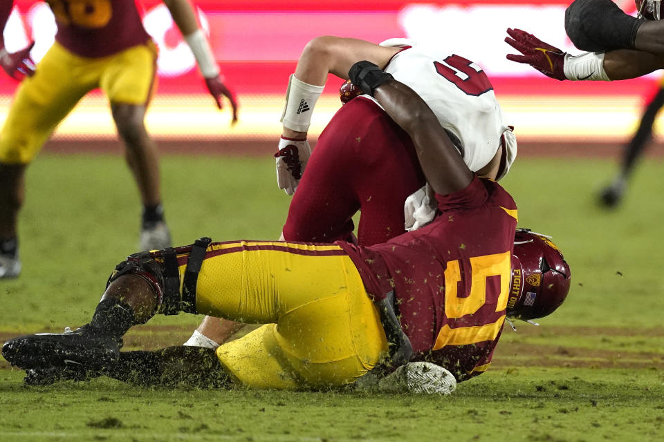 Fresno State quarterback Jake Haener, top, is sacked by Southern California defensive lineman Solomon Byrd during the second half of an NCAA college football game Saturday, Sept. 17, 2022, in Los Angeles. Haener was injured on the play and had to leave the game. (AP Photo/Mark J. Terrill)