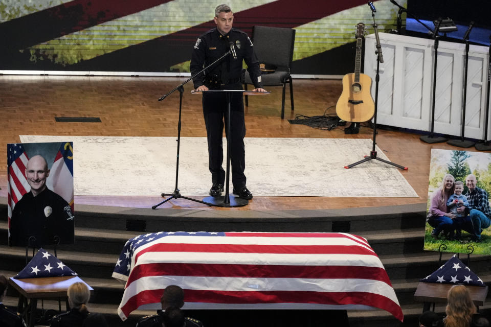 An official speaks during a memorial service for Officer Joshua Eyer, Friday, May 3, 2024, in Charlotte, N.C. Police in North Carolina say a shootout that killed Eyer and wounded and killed other officers began as officers approached a home to serve a felony warrant on Monday. (AP Photo/Chris Carlson)