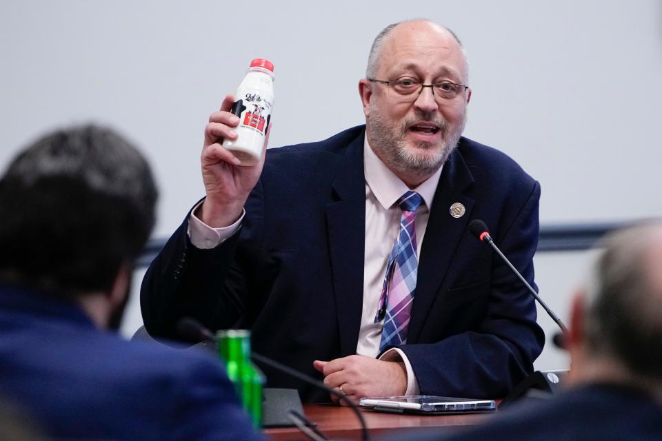 State Rep. Gary Click, R-Vickery, holds up a bottle of milk while giving testimony at the Ohio Department of Education during a board meeting Wednesday regarding a resolution that opposes proposed changes to Title IX, the federal law that prohibited discrimination in schools on the basis of sex. Adam Cairns/The Columbus Dispatch