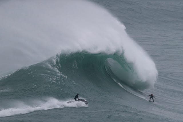 Surfers take on world's biggest waves (video)