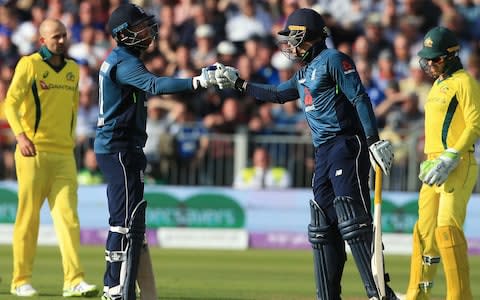 Jonny Bairstow touches gloves with Jason Roy - Credit: AFP