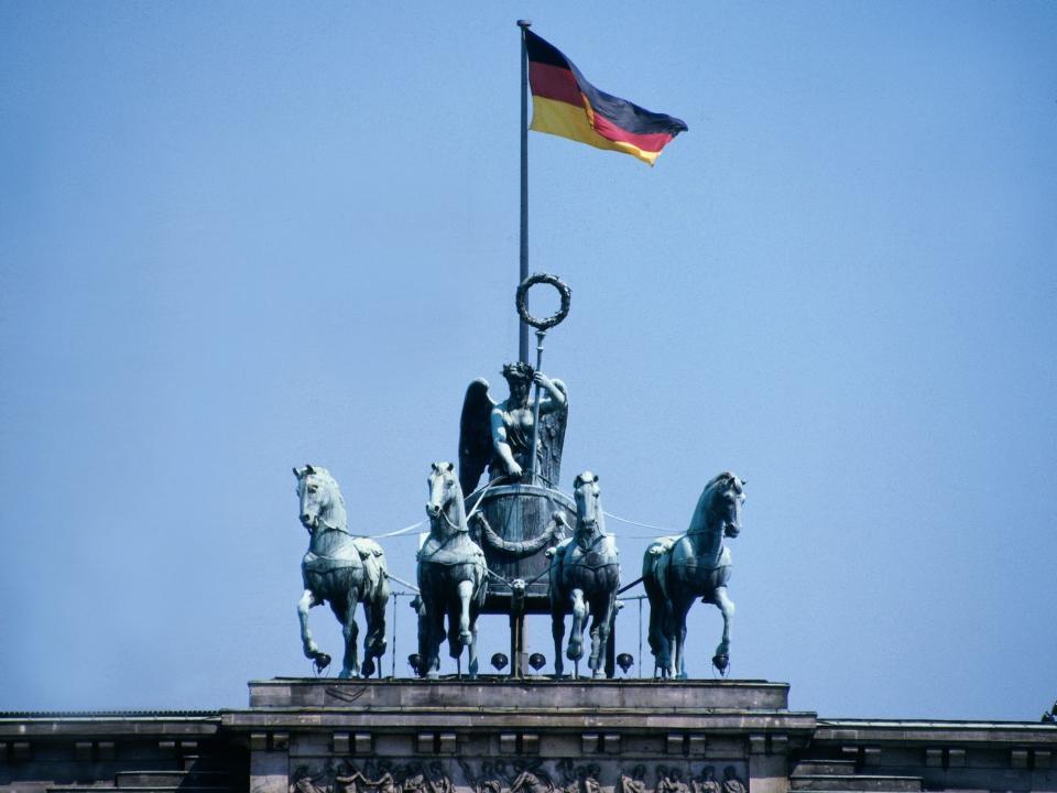 A German flag waves above the Brandenburg Gate, as seen in 1900.