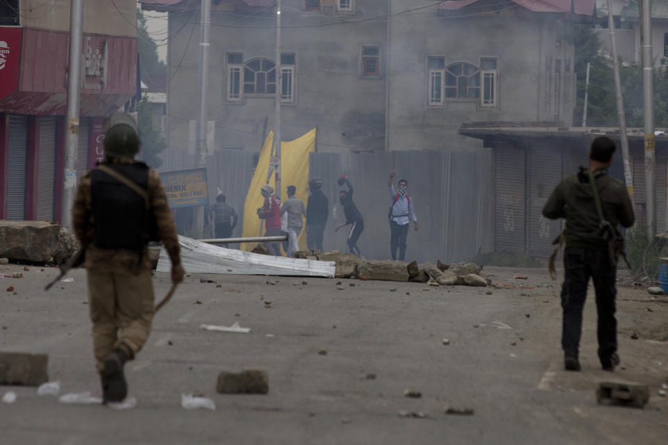 Indian police and Kashmiri protesters clash during a protest near the site of a gunbattle in Pulwama, south of Srinagar, Indian controlled Kashmir, Thursday, May 16, 2019. Three rebels, an army soldier and a civilian were killed early Thursday during a gunbattle in disputed Kashmir that triggered anti-India protests and clashes, officials and residents said. (AP Photo/ Dar Yasin)