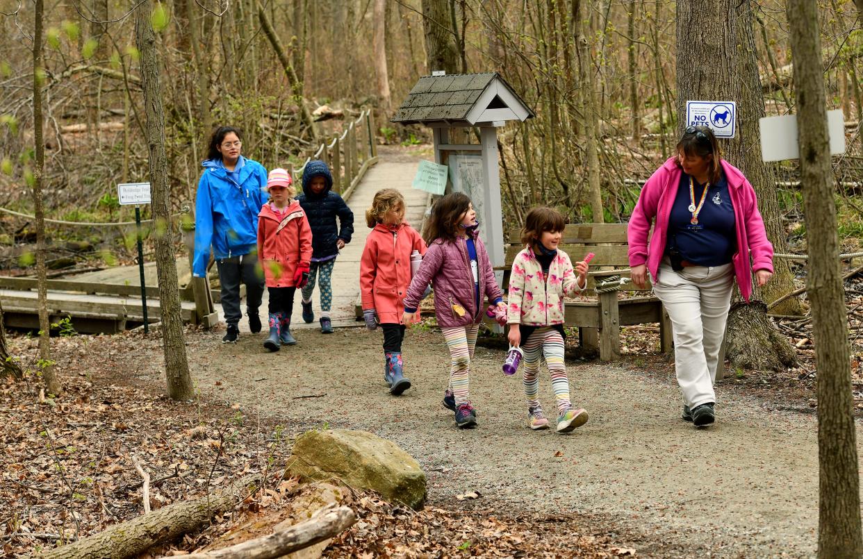 Children return for lunch from a April vacation program at Broad Meadow Brook Conservation Center and Wildlife Sanctuary after searching for flowers and new growth in the woods, meadows and vernal pools. Every day this week features a new theme and Tuesday was flowers.