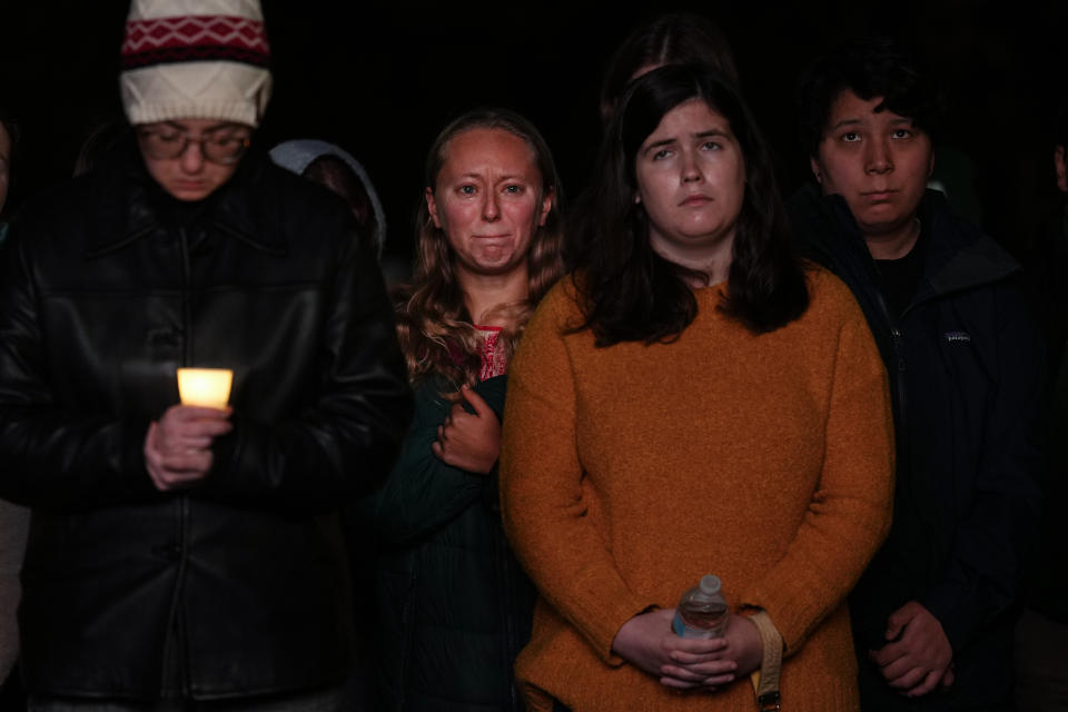 People gather at a vigil for the victims of Wednesday's mass shootings, Sunday, Oct. 29, 2023, outside the Basilica of Saints Peter and Paul in Lewiston, Maine. (AP Photo/Matt Rourke)