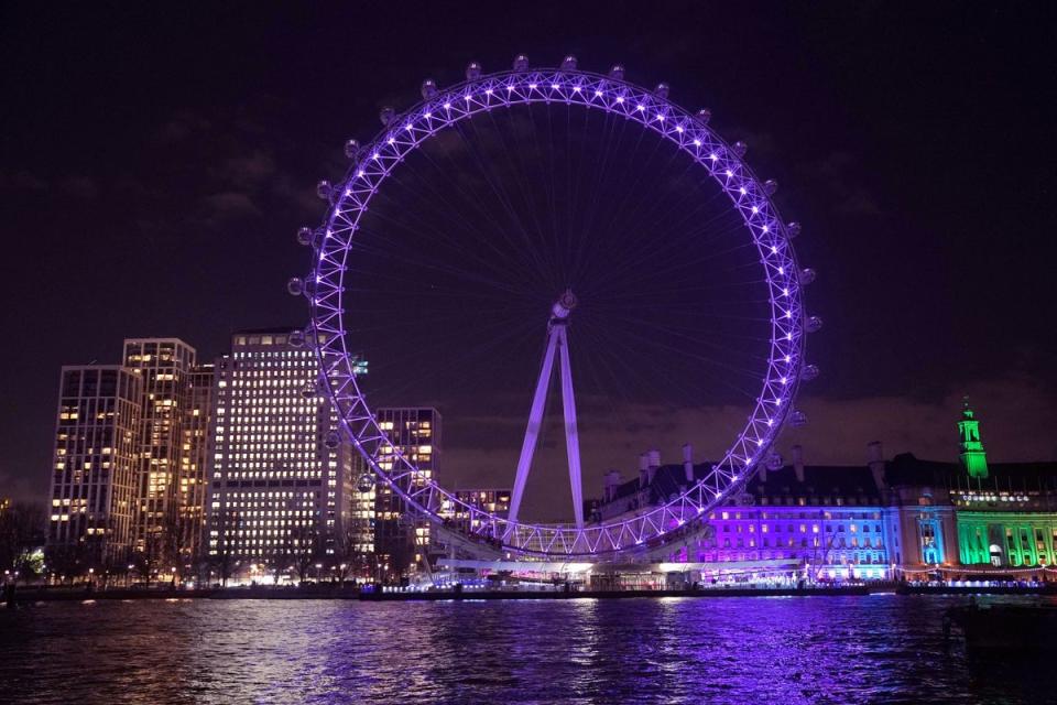 The London Eye is lit up purple to mark Holocaust Memorial Day 2023 (PA)