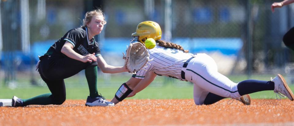 Cathedral Fighting Irish Maddie Liter (33) slides into second base against Westfield Shamrocks Sofia Easterhaus (1) on Saturday, April 13, 2024, during the game at the Cathedral High School in Indianapolis.