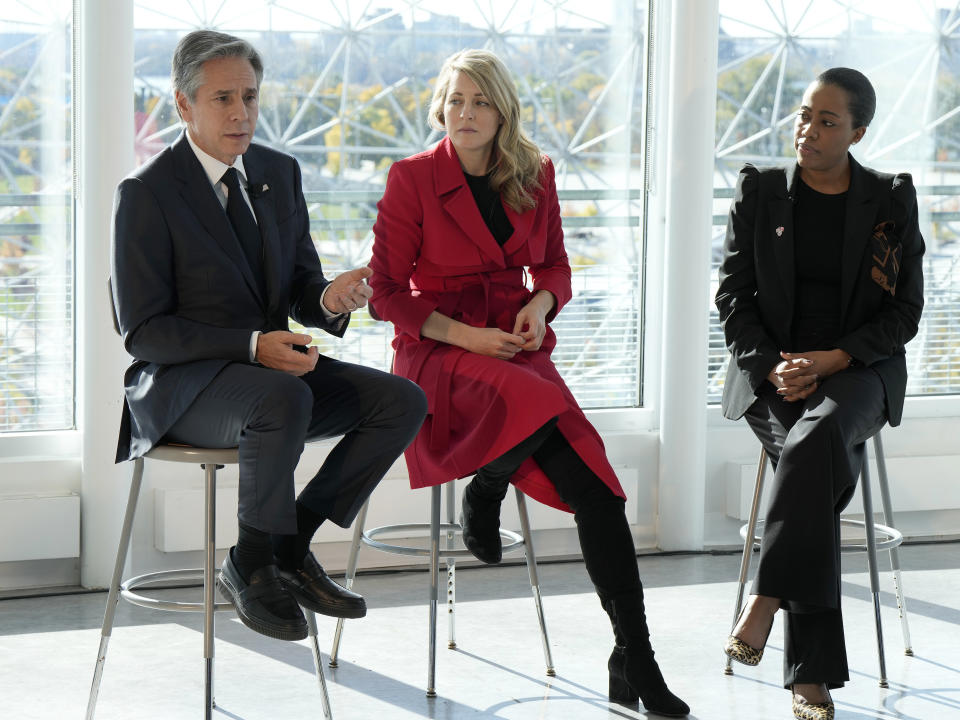 US Secretary of State Antony Blinken and Minister of Foreign Affairs Melanie Joly speak during a presentation to students at the Biosphere in Montreal, Friday, Oct. 28, 2022. Moderator Martina St-Victor looks on at right. (Ryan Remiorz /The Canadian Press via AP)