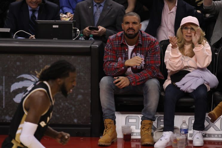 Drake and his mom Sandi Graham sitting court side.