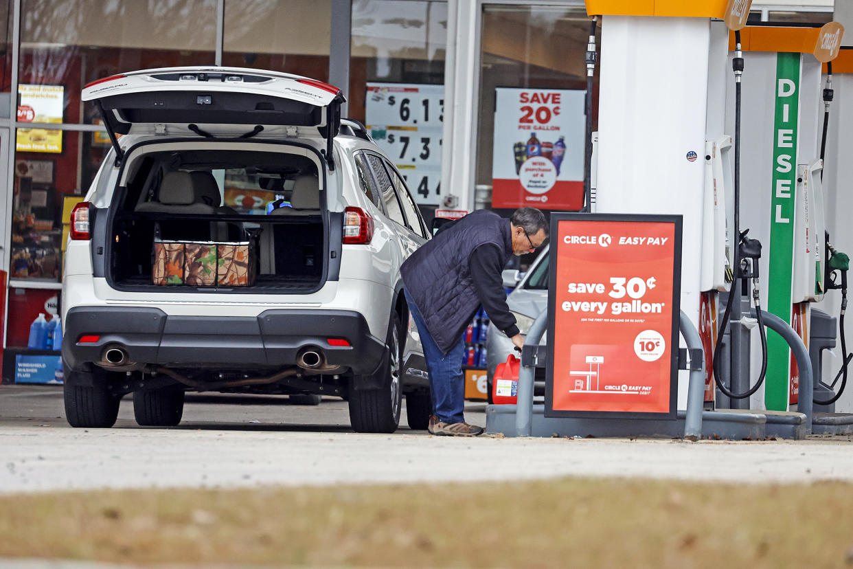 Residents fill gas containers just outside the affected area where a serious attack on critical infrastructure has caused a power outage to many around Southern Pines, N.C., on Dec. 5, 2022. (Karl B DeBlaker / AP)